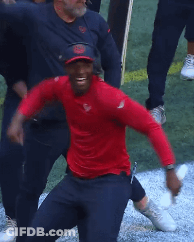 Man In Red Shirt And Blue Hat Next To Another Man GIF