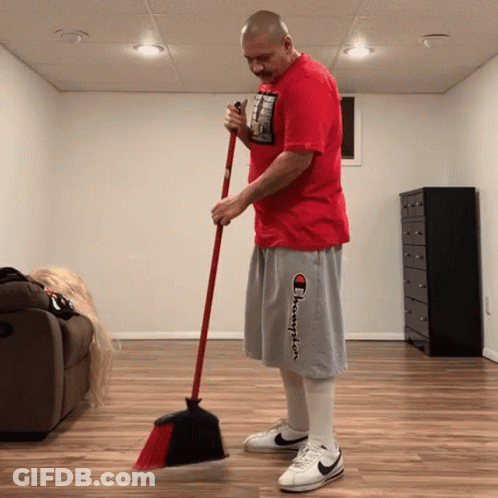 Man In Red Shirt And Gray Shorts Sweeping GIF