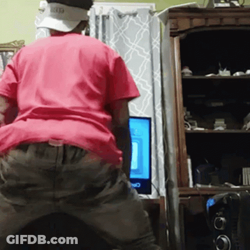 Man In Red Shirt And Hat At Computer GIF