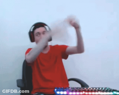 Man In Red Shirt And Headphones At Desk With Keyboard GIF