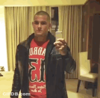 Man In Red Shirt And Leather Jacket Taking Selfie GIF
