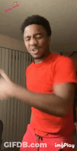 Man In Red Shirt And Red Shorts Dancing In Living Room GIF