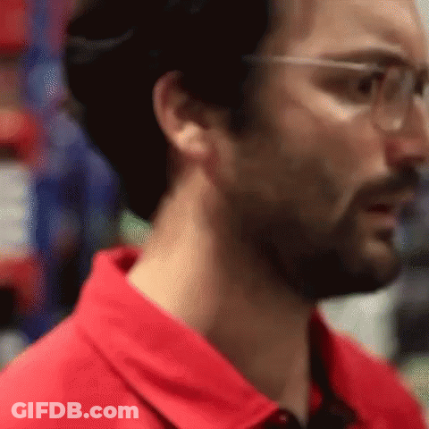 Man In Red Shirt And Safety Glasses Looking GIF