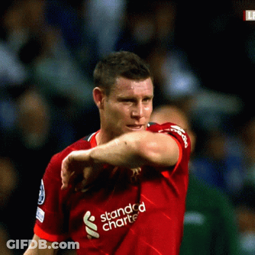 Man In Red Shirt And Shorts Removing Shirt GIF