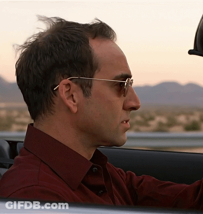 Man In Red Shirt And Sunglasses Driving Car GIF