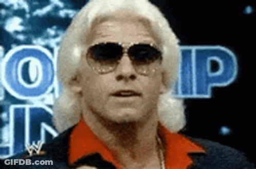 Man In Red Shirt And Sunglasses In Front Of WP Sign GIF