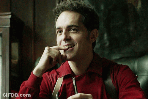 Man In Red Shirt And Suspenders Biting Nails GIF