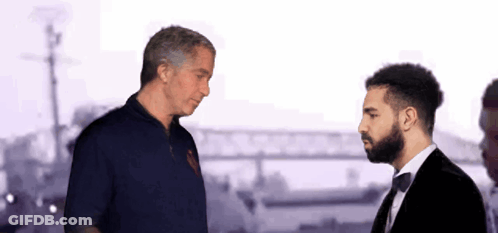 Man In Red Shirt And Tuxedo Talking GIF
