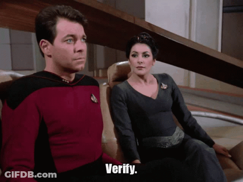 Man In Red Shirt And Woman In Black Dress Saying Verify GIF