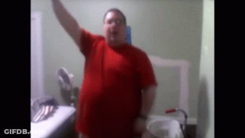 Man In Red Shirt At Bathroom Sink GIF