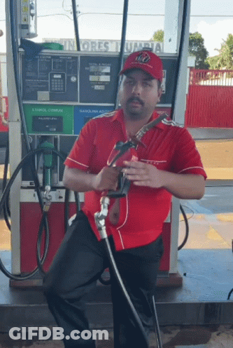 Man In Red Shirt At Gas Pump GIF