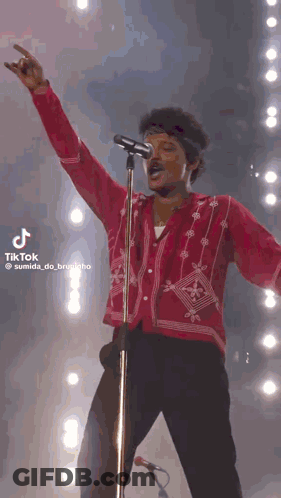 Man In Red Shirt At Microphone GIF