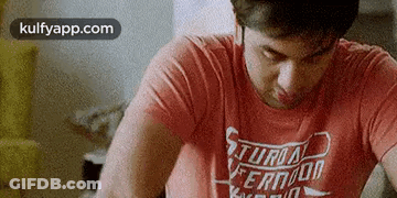 Man In Red Shirt At Table Eyes Closed GIF