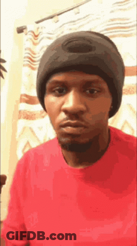 Man In Red Shirt Black Beanie Looking Camera GIF