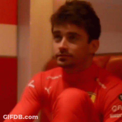 Man In Red Shirt Covering Mouth GIF