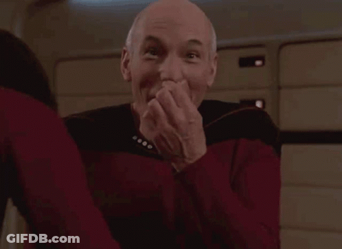Man In Red Shirt Covering Mouth Laughing GIF