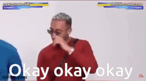 Man In Red Shirt Covering Nose GIF