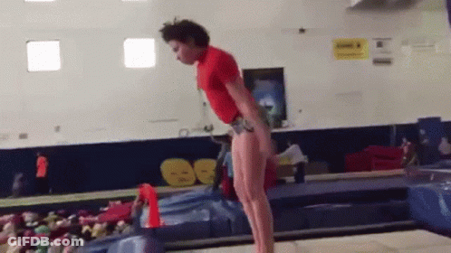 Man In Red Shirt Doing Balance Beam Trick GIF