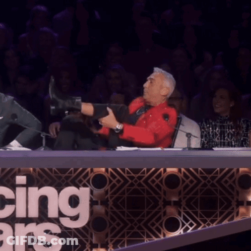 Man In Red Shirt Doing Split In Front Of Dancing With The Stars Sign GIF
