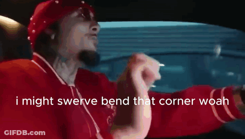 Man In Red Shirt Driving Saying I Might Swerve Bend That Corner Woah GIF
