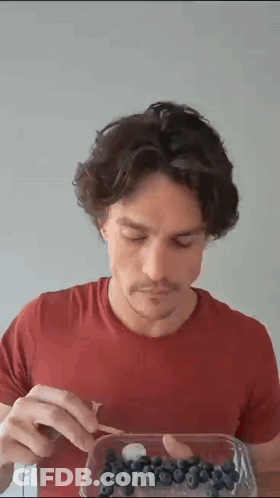 Man In Red Shirt Eating Blueberries GIF