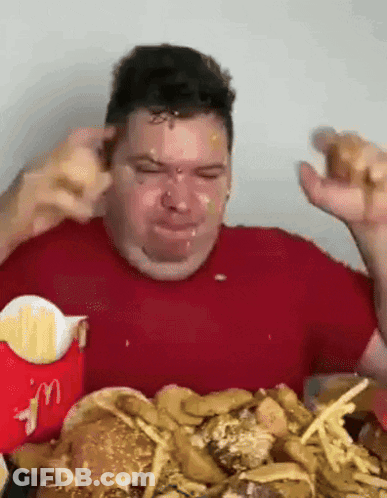 Man In Red Shirt Eating Hamburger And Fries GIF