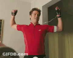 Man In Red Shirt Flexing GIF