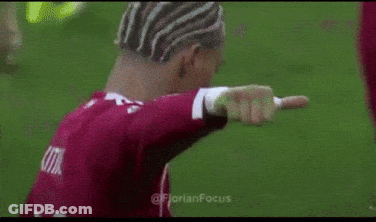 Man In Red Shirt Giving Thumbs Up On Soccer Field GIF