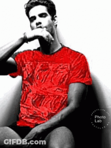 Man In Red Shirt Hand On Chin In Chair GIF