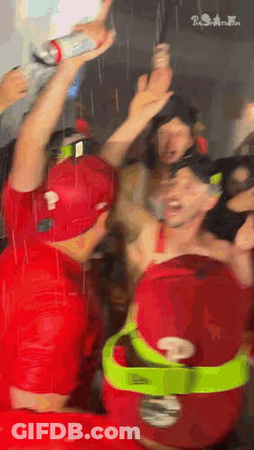 Man In Red Shirt Holding Bottle GIF