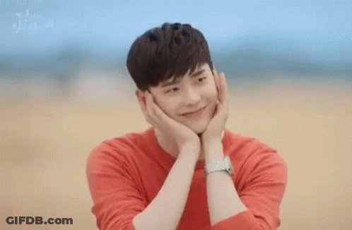 Man In Red Shirt Holding Face Smiling GIF