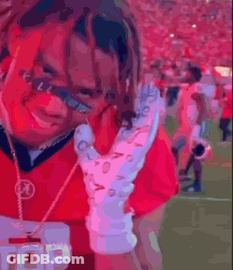Man In Red Shirt Holding Glove And Badge GIF