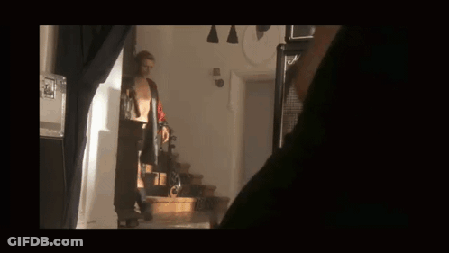 Man In Red Shirt Holding Gun GIF