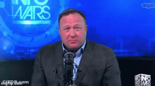 Man In Red Shirt Holding Gun Near Wheelchair GIF