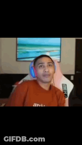 Man In Red Shirt Holding Head In Front Of TV GIF