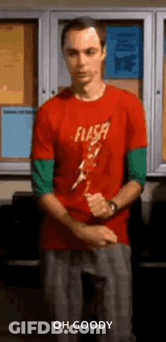 Man In Red Shirt Holding Lightning Bolt At Bulletin Board GIF