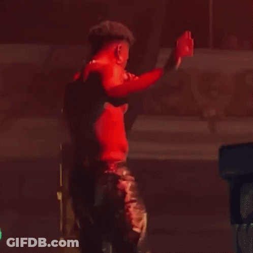 Man In Red Shirt Holding Microphone On Stage GIF
