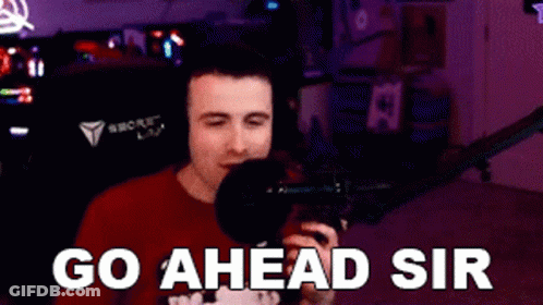 Man In Red Shirt Holding Microphone Says Go Ahead Sir GIF