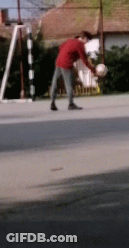 Man In Red Shirt Holding Soccer Ball GIF