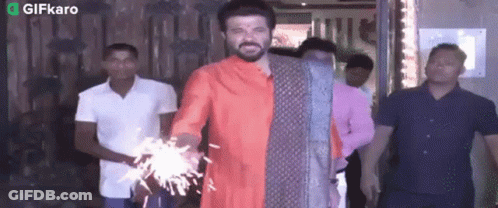 Man In Red Shirt Holding Sparkler GIF
