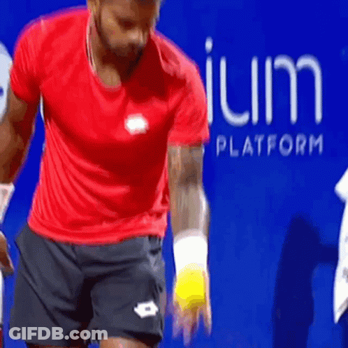 Man In Red Shirt Holding Tennis Ball Blue Sign Platform GIF