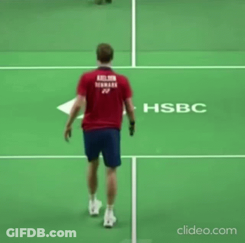 Man In Red Shirt Holding Tennis Racket On Court GIF