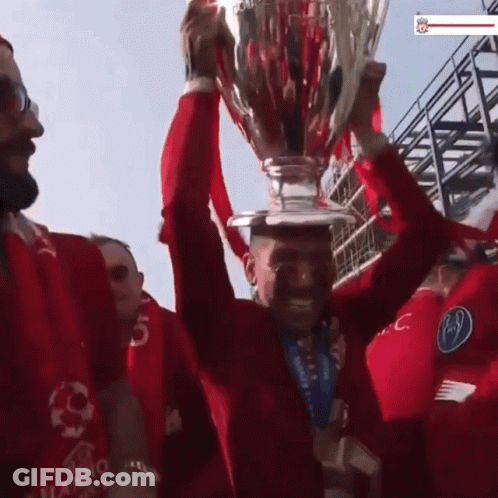 Man In Red Shirt Holding Trophy GIF