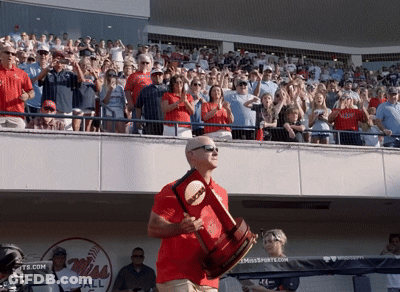 Man In Red Shirt Holding Trophy At Baseball Game GIF