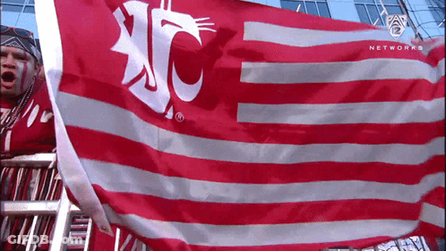 Man In Red Shirt Holding UC Flag GIF