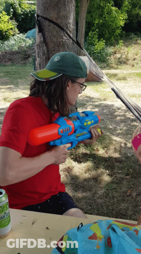 Man In Red Shirt Holding Water Gun Summer GIF