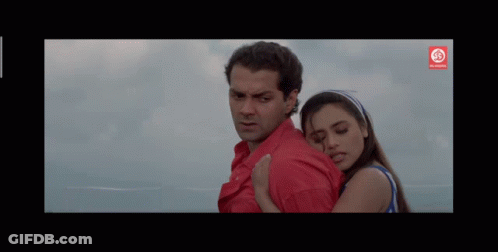Man In Red Shirt Hugging Woman In Blue Tank Top GIF