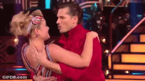 Man In Red Shirt Hugging Woman In Striped Dress GIF