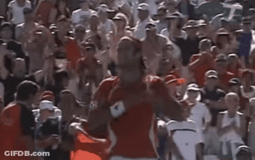 Man In Red Shirt In Front Of Crowd GIF