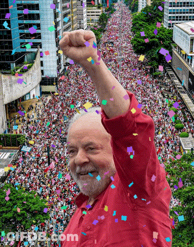 Man In Red Shirt In Front Of Crowd GIF